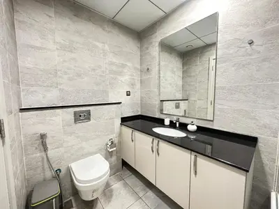 a bathroom with a toilet and a sink and a mirror at Stunning 1-Bedroom in The Polo Residence, Meydan in Dubai