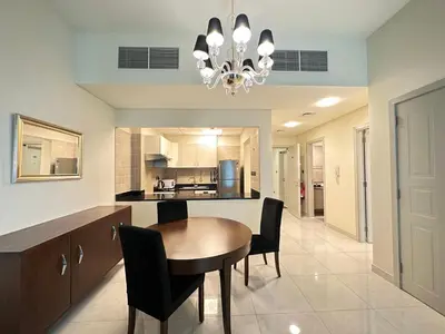 a dining room with a table and chairs in a kitchen at Stunning 1-Bedroom in The Polo Residence, Meydan in Dubai