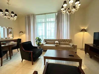 a living room with a couch and a table at Stunning 1-Bedroom in The Polo Residence, Meydan in Dubai