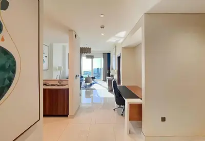 an open living room with a kitchen and a dining room at Livbnb - 1B Palm Jumeirah and Sea View at Avani in Dubai