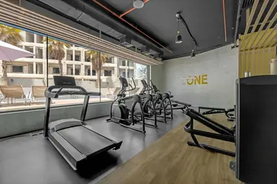 a gym with a row of exercise bikes in a room at Comfy JVC Studio Pantheon Comfort & Style by Vibel in Dubai