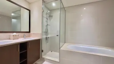 a bathroom with a shower and a sink and a tub at Guest Favorite - Modern 3BR High Views Prime Location at Downtown in Dubai