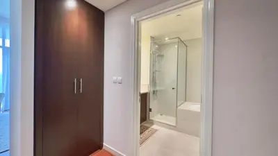 a bathroom with a glass door leading to a shower at Guest Favorite - Modern 3BR High Views Prime Location at Downtown in Dubai