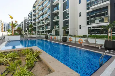 a large swimming pool in front of a building at Trendy Azizi Riviera 1-Bed with Balcony Views in Dubai