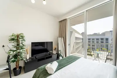 a bedroom with a large bed and a balcony at Art of Modern Illumination in Dubai