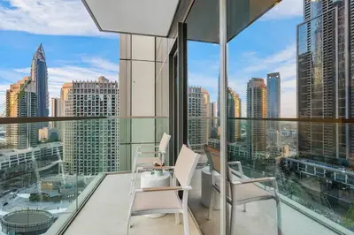 a balcony with chairs and a view of the city at FIRST CLASS 1BR Charming City View in Dubai