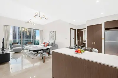 a kitchen and living room with a couch and a table at FIRST CLASS 1BR Charming City View in Dubai