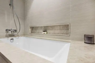 a white bath tub in a bathroom with a shower at FIRST CLASS 1BR Charming City View in Dubai