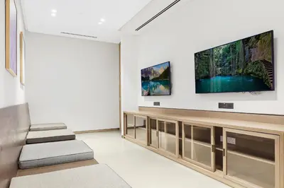 a living room with a flat screen tv on a wall at FIRST CLASS 1BR Charming City View in Dubai