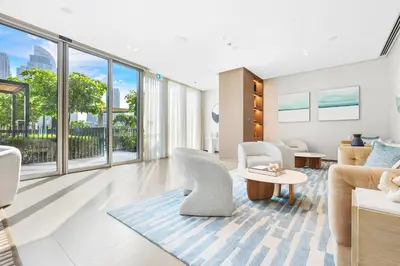 a living room with white furniture and large windows at FIRST CLASS 1BR Charming City View in Dubai