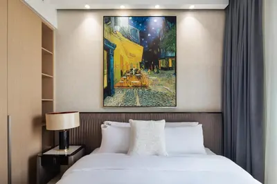 a bedroom with a bed and a painting on the wall at Waterfront Apartment at Dubai Creek Harbour - By DuStay in Dubai