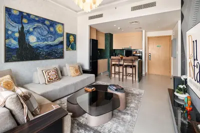 a living room with a couch and a table at Waterfront Apartment at Dubai Creek Harbour - By DuStay in Dubai