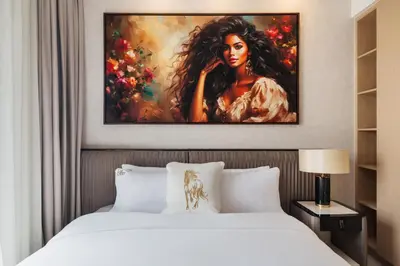 a bedroom with a bed and a painting of a woman at Community view home-Dubai Creek Harbour - By DuStay in Dubai
