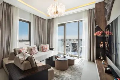 a living room with a couch and a large window at Community view home-Dubai Creek Harbour - By DuStay in Dubai