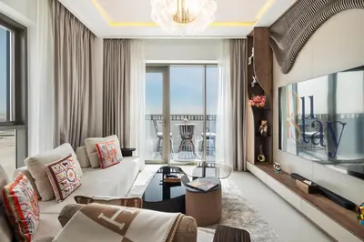 a living room with a couch and a tv at Community view home-Dubai Creek Harbour - By DuStay in Dubai
