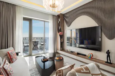 a living room with a large television and a couch at Community view home-Dubai Creek Harbour - By DuStay in Dubai