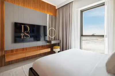 a bedroom with a bed and a flat screen tv at Community view home-Dubai Creek Harbour - By DuStay in Dubai