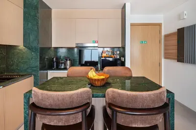 a kitchen with a table with a bowl of bananas on it at Luxurious Apartment, Dubai Creek Harbour - By Dustay in Dubai