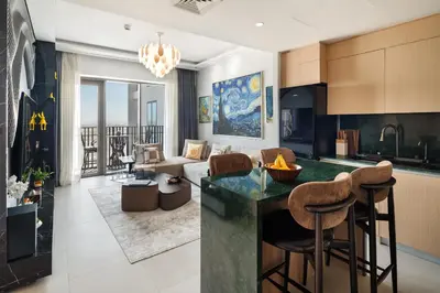 a kitchen and living room with a couch and a table at Luxurious Apartment, Dubai Creek Harbour - By Dustay in Dubai