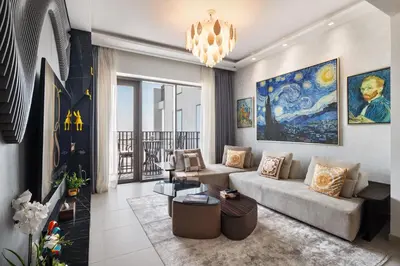 a living room with a couch and a chandelier at Luxurious Apartment, Dubai Creek Harbour - By Dustay in Dubai