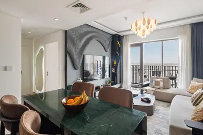 a living room with a table with a bowl of fruit on it at Luxurious Apartment, Dubai Creek Harbour - By Dustay in Dubai