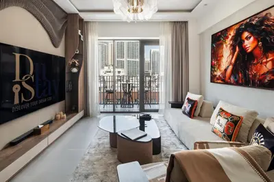 a living room with a large painting on the wall at Dubai Creek Poolside view Apartment - By DuStay in Dubai