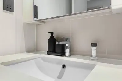 a kitchen sink with a black soap dispenser on it at FIRST CLASS 1BR Stunning Marina & Palm View in Dubai