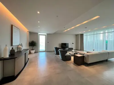 a large living room with a couch and a television at FIRST CLASS 1BR Stunning Marina & Palm View in Dubai