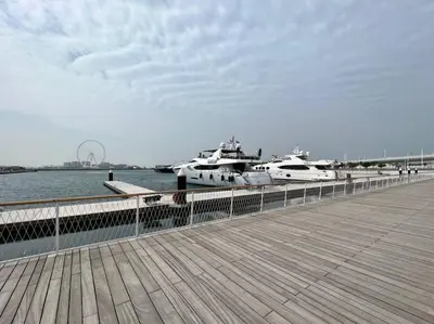 two boats are docked next to a pier at FIRST CLASS 1BR Stunning Marina & Palm View in Dubai