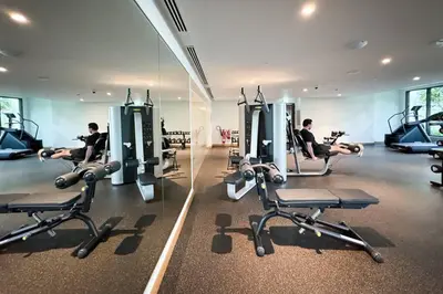 a gym with several people exercising on tread machines at Stunning 1 bedroom Apartment w Burj Khalifa View in Dubai