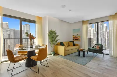 a living room with a table and a couch at Stunning 1 bedroom Apartment w Burj Khalifa View in Dubai