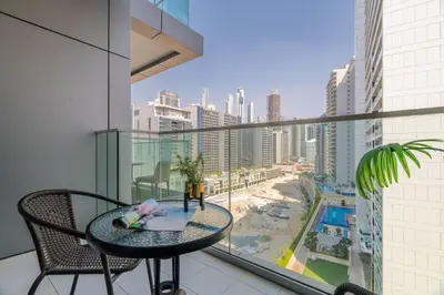 a balcony with a table and a view of a city at GuestReady - Luxurious studio in Business Bay in Dubai