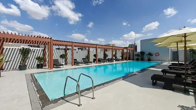 a swimming pool on top of a building at New Charming Studio in JVC in Dubai