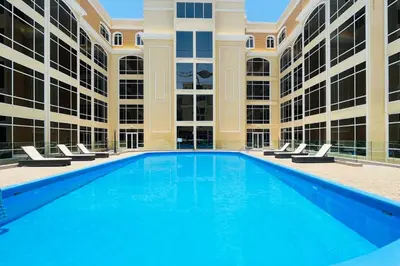 an empty swimming pool in front of a building at Livbnb-Spacious JVC Studio, Near Dining and Shops in Dubai