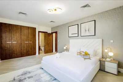 a large white bedroom with a large white bed at Livbnb Suites - Burj Khalifa View 2BR spacious apt in Dubai
