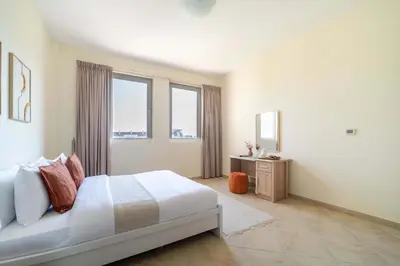 a bedroom with a bed and two windows at Frank Porter - Widcombe House 3 in Dubai