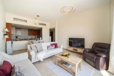 a living room with a couch and a table at Frank Porter - Widcombe House 3 in Dubai