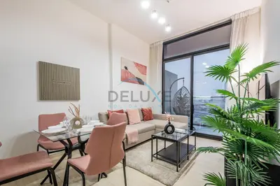 a living room with a couch and a table at Modern 1BR Apartment in Binghatti Luna, Jumeirah Village Circle by Deluxe Holiday Homes in Dubai