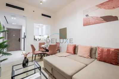 a living room with a couch and a table at Modern 1BR Apartment in Binghatti Luna, Jumeirah Village Circle by Deluxe Holiday Homes in Dubai
