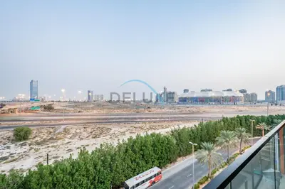 a view of a highway with a city in the background at Modern 1BR Apartment in Binghatti Luna, Jumeirah Village Circle by Deluxe Holiday Homes in Dubai