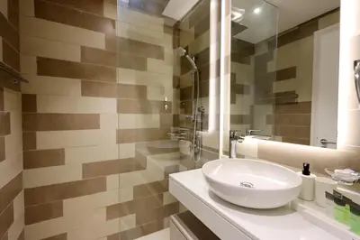 a bathroom with a white sink and a mirror at Exquisite Studio near Nakheel Mall by Livbnb in Dubai