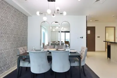 a dining room with a table and chairs at Livbnb - 3BR Plus 1 with Burj and Fountain Views in Dubai
