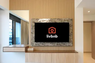 a tv on a wall in a lobby at Livbnb - 3BR Plus 1 with Burj and Fountain Views in Dubai