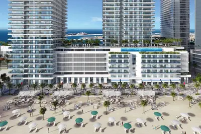 an aerial view of a building with palm trees and buildings at Livbnb-Beachfront 3BR with Marina Harbour Panorama in Dubai