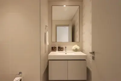 a bathroom with a white sink and a mirror at Livbnb-Beachfront 3BR with Marina Harbour Panorama in Dubai