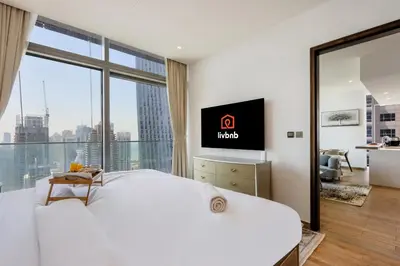 a hotel room with a large bed and a large window at 2BR Sunset View Suite -Jumeirah Living Marina Gate in Dubai