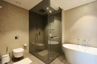 a bathroom with a tub and a toilet and a sink at 2BR Sunset View Suite -Jumeirah Living Marina Gate in Dubai