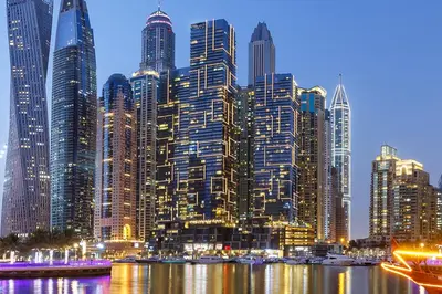 a large city with tall skyscrapers at night at 2BR Sunset View Suite -Jumeirah Living Marina Gate in Dubai