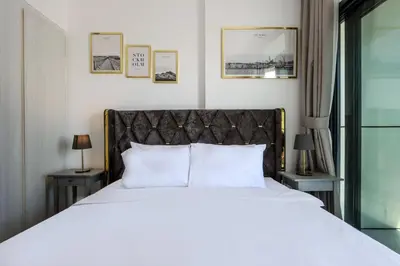 a bedroom with a large bed with white sheets and pillows at Canalfront Gem 1BR in Zada Tower by Livbnb in Dubai