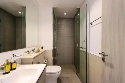 a bathroom with a toilet and a sink and a shower at Canalfront Gem 1BR in Zada Tower by Livbnb in Dubai